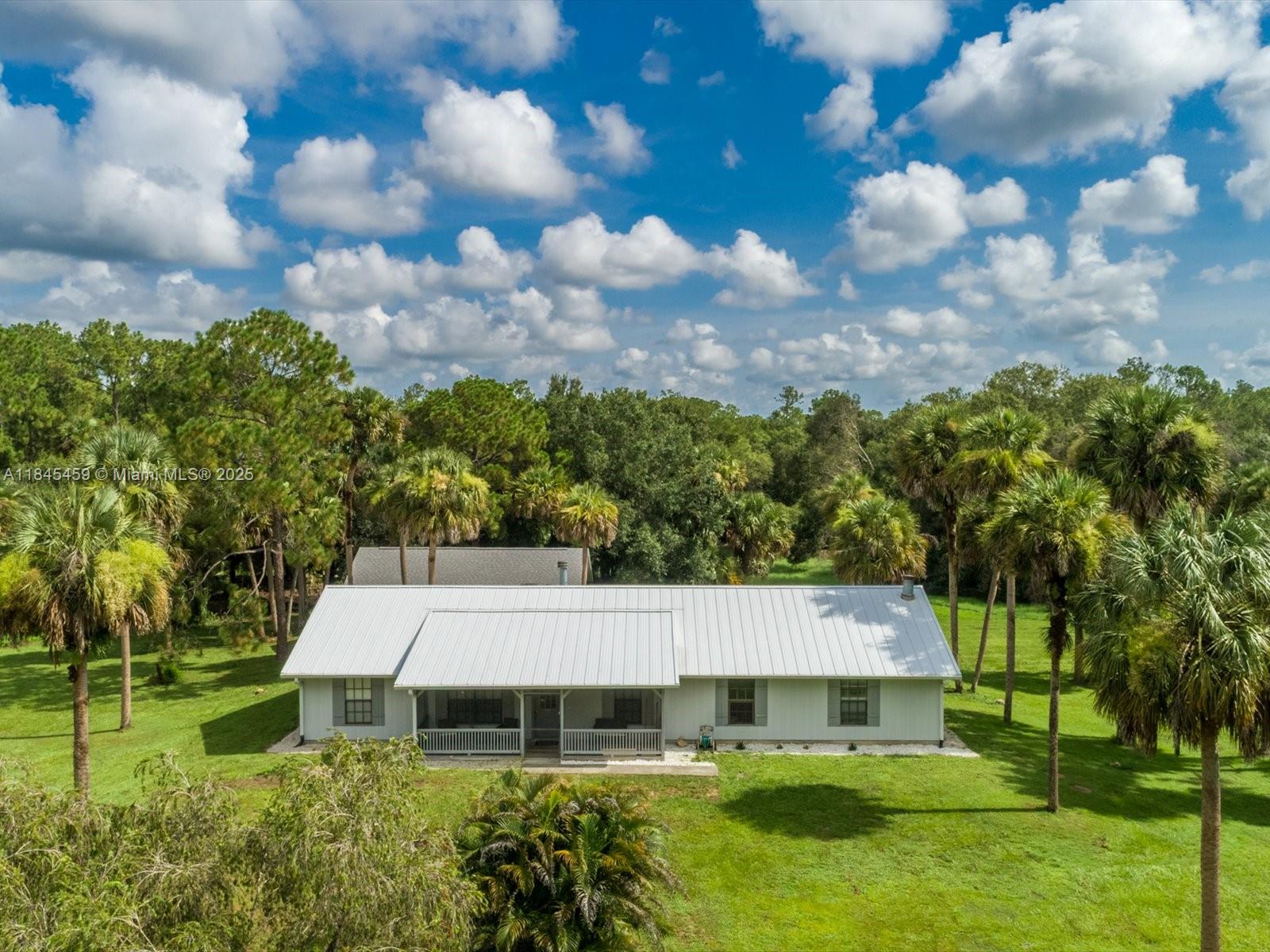 Endless potential on 5 private, usable acres! This estate offers the perfect blend of space, flexibility and function ideal for horses or creating your dream setup. The main house features 4 spacious bedrooms and 3 bathrooms, while the secondary building has a brand new shingle roof with plenty of options for future use. This meticulously maintained home brings peace of mind with major upgrades throughout: a new well with a reverse osmosis filtration system and a large reservoir tank that can supply clean drinking water for up to a week during power outages. New tile flooring, fresh paint, new washer/dryer, two new AC units, fully redone drain field, a new metal roof on the main house, new gutters and a driveway expansion, making this property as practical as it is peaceful. See it today!