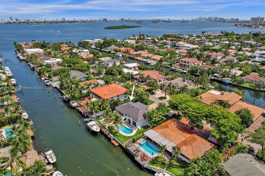 Beautifully remodeled two-story waterfront estate located in the exclusive gated community of Sans Souci Estates on a rare larger than normal extra wide lot 12,500sqft. No expenses spared, 4/3.5, extra long 2car garage, NEW ROOF, NEW IMPACT WINDOWS, NEWER DOCK, porcelain tile floors throughout. No fix bridges, quick ocean access, extra long 100 FT of waterfront perfect for bigger boats or multiple boats on an extra wide canal w/a NEW 30k lb boat lift. Large open kitchen, great for any chef w/Italian cabinets, quartz counters, 48" viking gas range 72" refrigerator/freezer & more. 2nd floor primary suite features a huge walk-in closet w/built-ins, huge Bath & private terrace overlooking the water. Sideyard big enough for a trailer or RV. Pergola w/outdoor kitchen! You will be IMPRESSED!