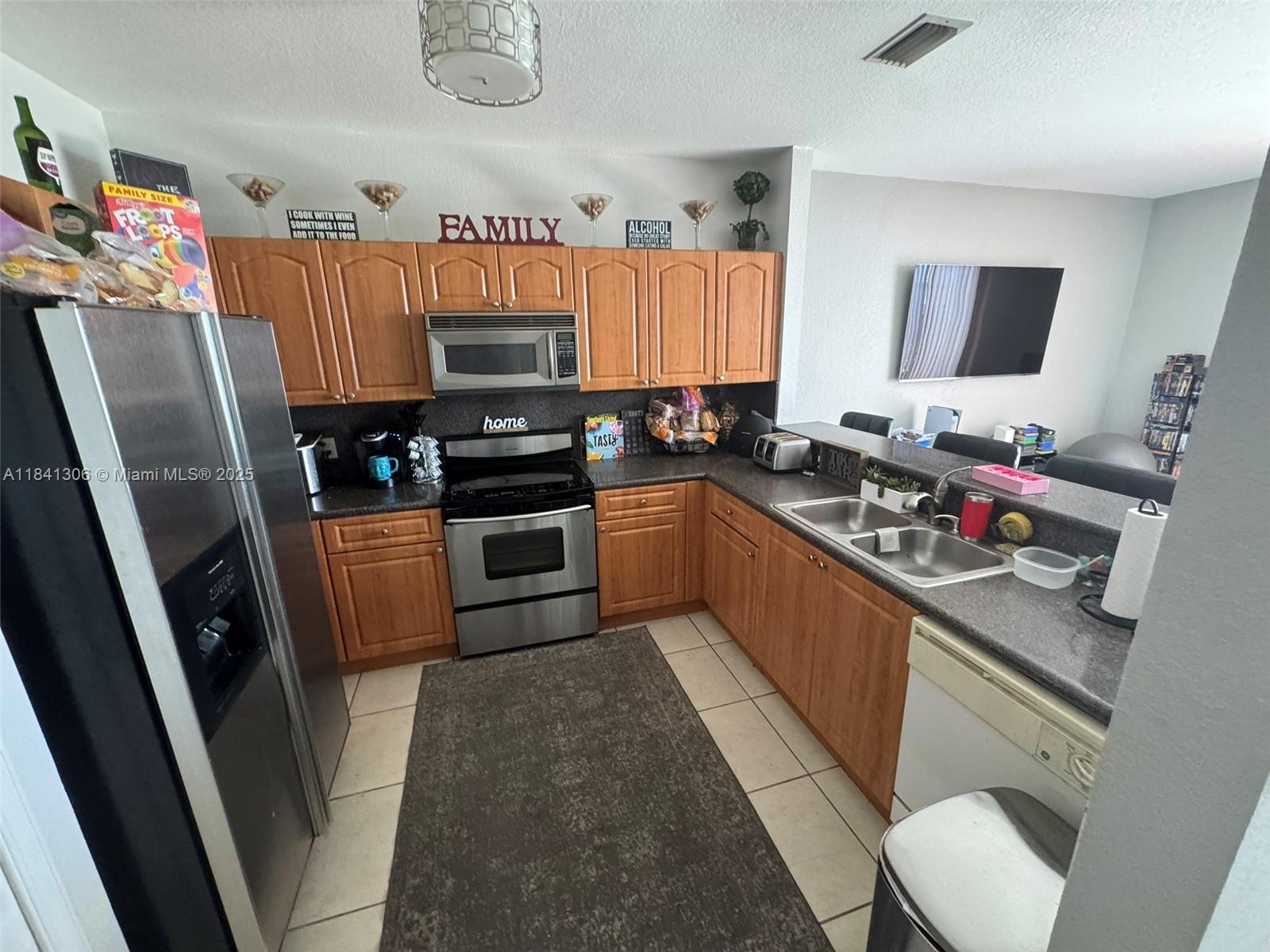 Fannie Mae approved condo—Priced to sell! Seller is willing to include furniture and appliances. One of the few units featuring a semi-enclosed front section, perfect for a home office or additional room. Kitchen and primary bathroom include select upgrades. Prime location just off I-75 in the Miramar/Pembroke Pines area. Gated community with 24/7 security and access to A+ rated schools: Dolphin, Glades, and Everglades. Beautiful pool area, gym, and other community amenities.