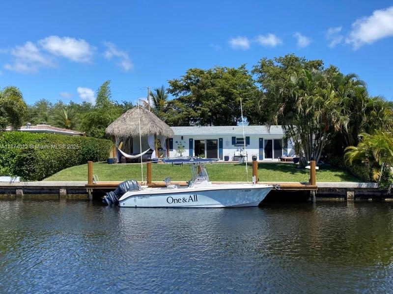 Waterfront pool dream home in East Pompano Beach w/ private boat dock. Renovated 3 BD/ 2BA pool home w/ an open floor plan, all impact windows & slider doors, full house generator. Upon entering you will see the amazing waterfront view. This property feels very spacious. Kitchen has lots of natural lighting & also water view. Florida room & master bedroom overlook the pool & dock. Luxury backyard retreat features a large saltwater pool, Tiki log hut, dock has water & 30amp service. Plantation shutters in front, filtered shades in back. Two Large storage units to store your toys. Security cameras, Large Circular paved private driveway. NO HOA. Close to Pompano Beach pier, Near A rated schools Calvary Christian Academy, Pine Crest & close to I-95, turnpike, and Holy Cross Hospital.