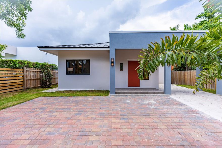 New home and move-in ready, this stunning home offers 2,300 sf of A/C space. With 3 bedrooms, 2.5 baths, and a spacious living room, dining room, and family room, there's plenty of room for everyone. The large open kitchen boasts quartz countertops, a pantry, a wet bar, volume ceilings and more. Enjoy breakfast in the bright kitchen breakfast area or relax on the 220 sf covered porch that overlooks the backyard. The covered entry with a partial porte-cochere provides parking for 3 cars, and an aluminum fence enhances the front yard. Featuring all tile floors, a metal roof, and impact windows, this home offers durability and style. A wonderful opportunity to make this brand new home your dream home. Close to the NEW GROVE CENTRAL & Underline soon.