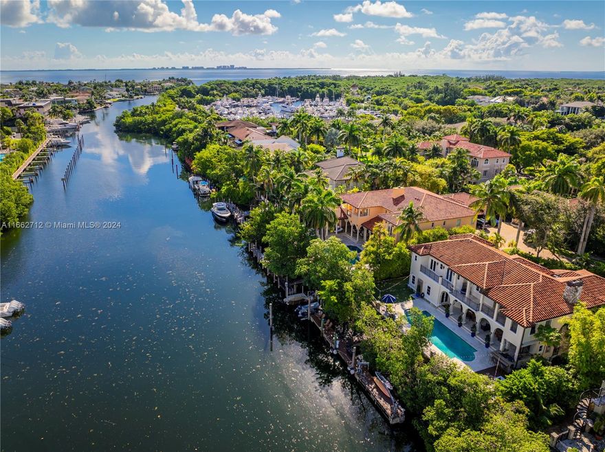 Enjoy exceptional WATERFRONT lifestyle with No bridges to bay and direct ocean access!  An elegant beautifully maintained 2 story residence located in a private cul-de-sac with 108 ft. of water frontage.  Completely updated in 2022 a foyer leads to a formal living & dining room, large eat-in kitchen & family room.  Guest bedroom + maids room, laundry room & guest bath.  2 car garage, 1 w/car lift. Upstairs are 4 ensuite bedrooms which includes the primary suite + office. Terrace w/ summer kitchen, cabana bath, spiral staircase to primary bedroom, heated saltwater pool, outdoor shower, ½ basketball court, 75ft dock with lift and jet ski floats, full hurricane protection. Islands of Cocoplum offers 24/7 security, clubhouse and tennis courts.