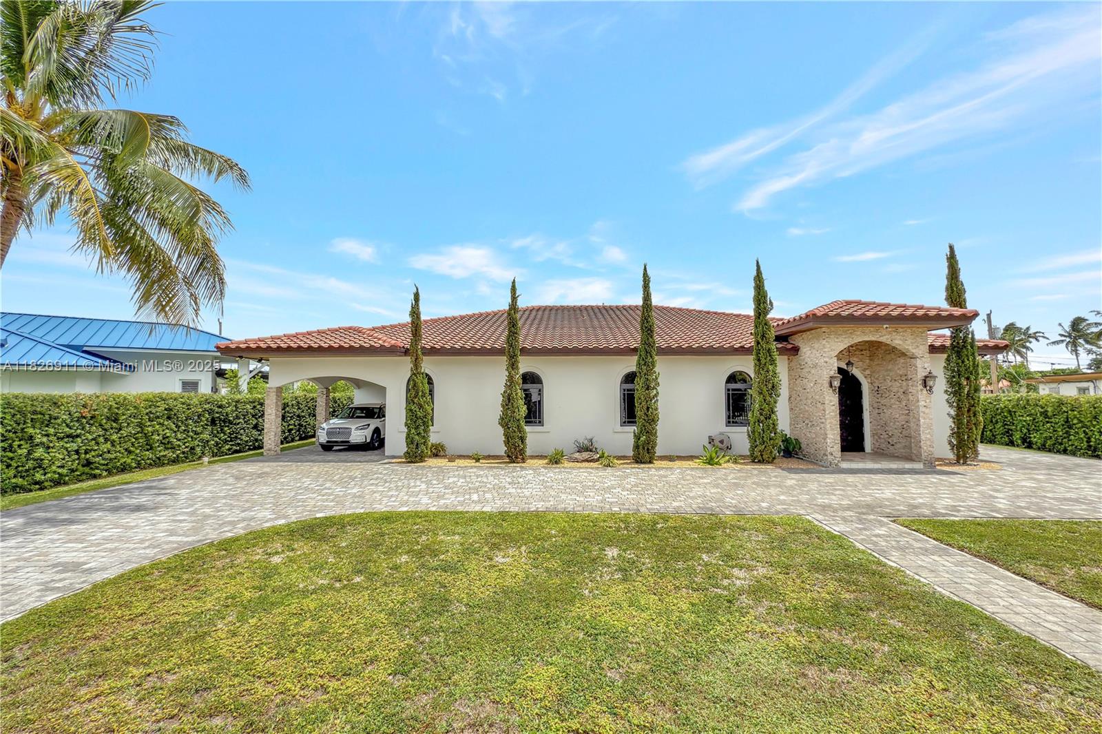 Fully rebuilt in 2018, this exceptional home offers security, modern design, and versatile living space. Featuring 3 bedrooms, each with its own en-suite bathroom, plus 2 additional half baths, this property is perfect for comfortable family living or entertaining guests. The third bedroom includes a fully equipped, eat-in kitchen—ideal for guests, extended family, or income potential. 2 additional rooms offer flexible use as additional bedrooms or offices. Entertain outdoors in the expansive 840 sq ft covered terrace, complete with a full outdoor kitchen, ceiling fans, and ample lighting. Extra detached 234 sq ft storage/utility room with full bathroom. Pre-wired for smart home/technology upgrades. Privacy, functionality, and entertainment-ready features, makes it a must-see!
