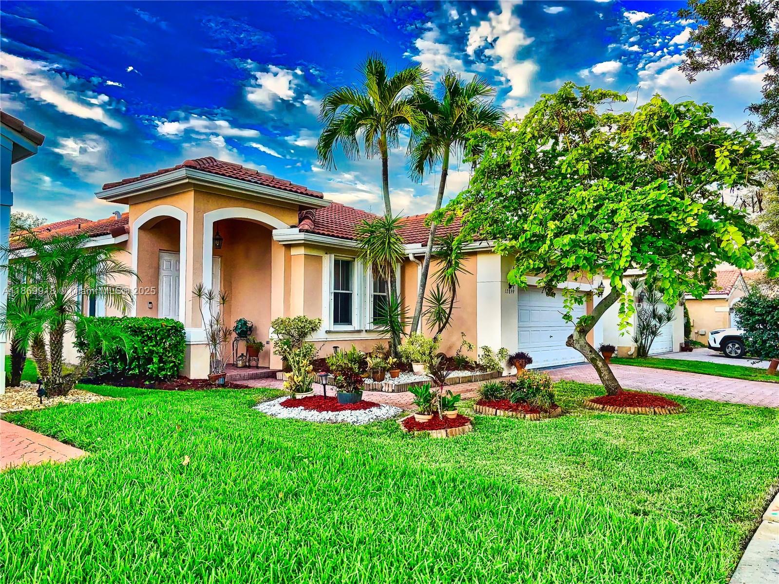 Move-in ready 3 bedroom, 2 bath home in the gated Melrose Landing at Monarch Lakes. This well maintained property features tray ceilings throughout and a spacious open lay out. The kitchen offers ample counter space and cabinetry, opening to the living and dining areas. The primary suite includes a walk-in closet, dual sinks, soaking tub and seperate shower. Additional highlights are a two-car garage and tropical backyard with an open patio, mango and banana trees. The home is also hurricane protected with accordian shutters. Enjoy community amenities including a pool, playground, tennis and basketball courts. Conveniently located near shops, dining, schools and major highways with easy access to Miami and Fort Lauderdale