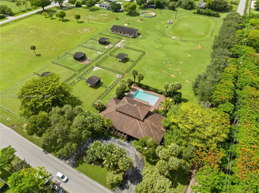 This outstanding equestrian property sits on a sprawling 4.38 Acre lot. It's well-designed barn w/7 stalls & air-conditioned office, 10 grass paddocks, large riding ring & ample pasture for grazing make this the perfect haven for you & your equine companions. The spacious home boasts 5,165 sq ft. w/unique spaces thoughtfully built to create an inviting atmosphere. The grand formal room w/bar & fireplace provide a sophisticated ambiance. The covered patio opens to an expansive pool deck providing space for outdoor relaxation. Every aspect of this residence speaks to the passion and dedication of its one and only original owners, their thoughtful design choices make this home an exceptional canvas for your unique touch. Agricultural tax exemption and income producing opportunity available!