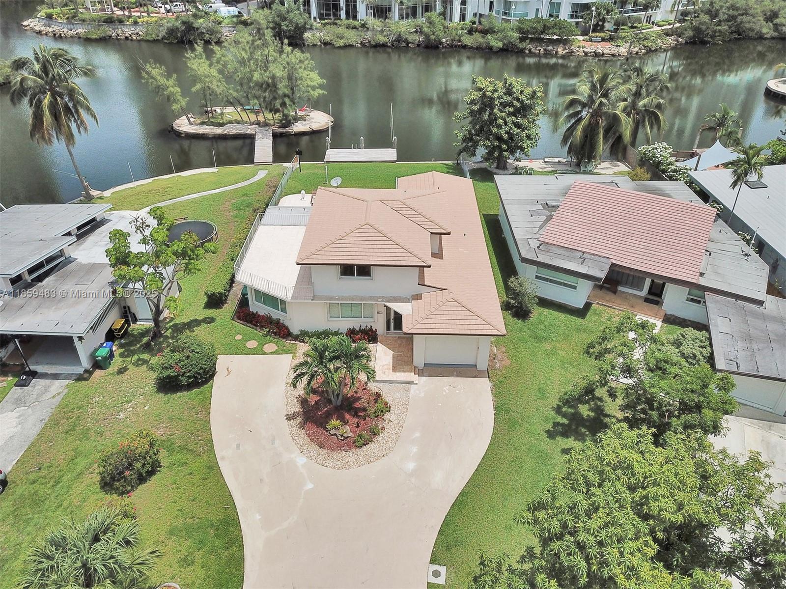 Waterfront living in the desired Atlantic Isle located on the Intracoastal Waterway. Private dock for up to 40' boat with no fixed bridges to ocean, and beach access across the street for Island residents. Atlantic Isle is a secluded island across the street from the beach with easy access to shopping, airport, Houses of Worship, Bal Harbour Shops and Aventura Mall. These 3 bed/3 baths, one car garage pool home features tile throughout, lots of natural light, kitchen with stainless steel countertop, and stainless-steel appliances. Hurricane accordion shutters for the entire home. Master bedroom conveniently located on first floor. Don't miss this beautiful home with beach and boating access.