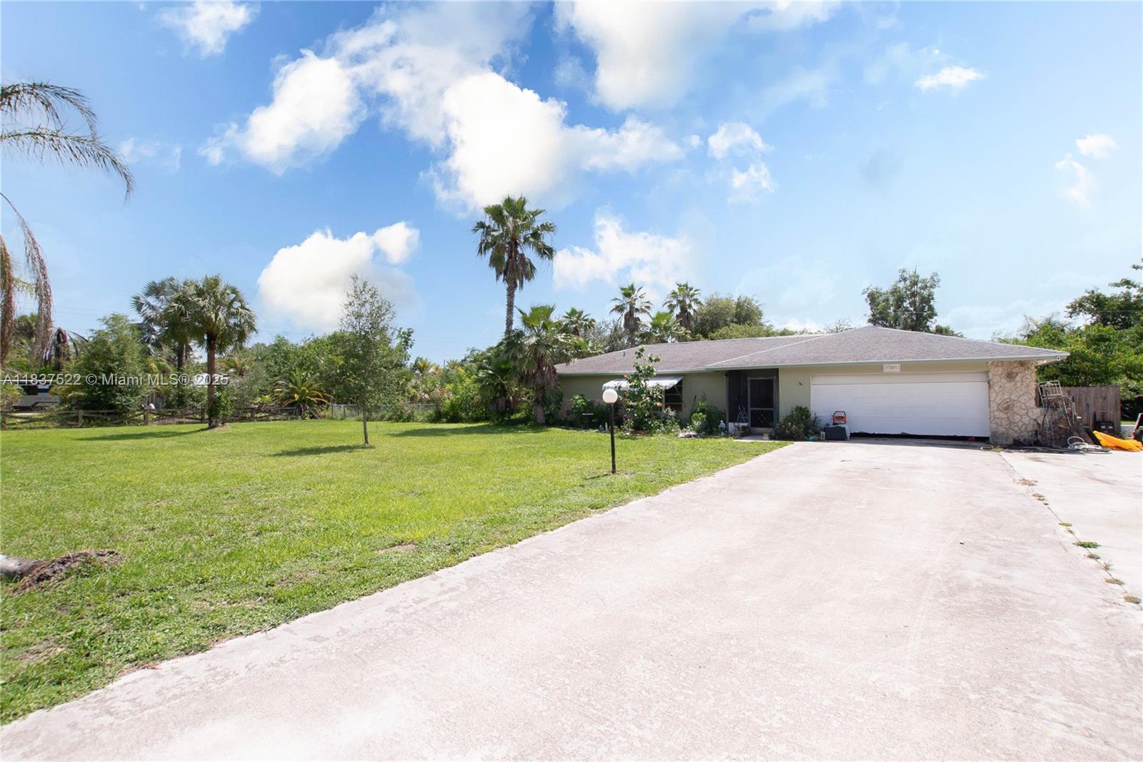 Investor Special: Concrete Block Home on a Full Acre - At just under 2,000 sq ft. this residence sits on a full acre just off Bayshore Road near I-75, offering an ideal opportunity for investors or buyers seeking land and the chance to make a space their own. Featuring a split-floor layout that balances privacy with versatility, the home’s heart is its spacious kitchen, complete with a pass-through bar that opens into the living area, adding character and flow. A fully fenced backyard invites creative landscaping, workshop possibilities, or storage expansion. This concrete block structure is ready for personalization, renovation, or expansion to reflect your vision.