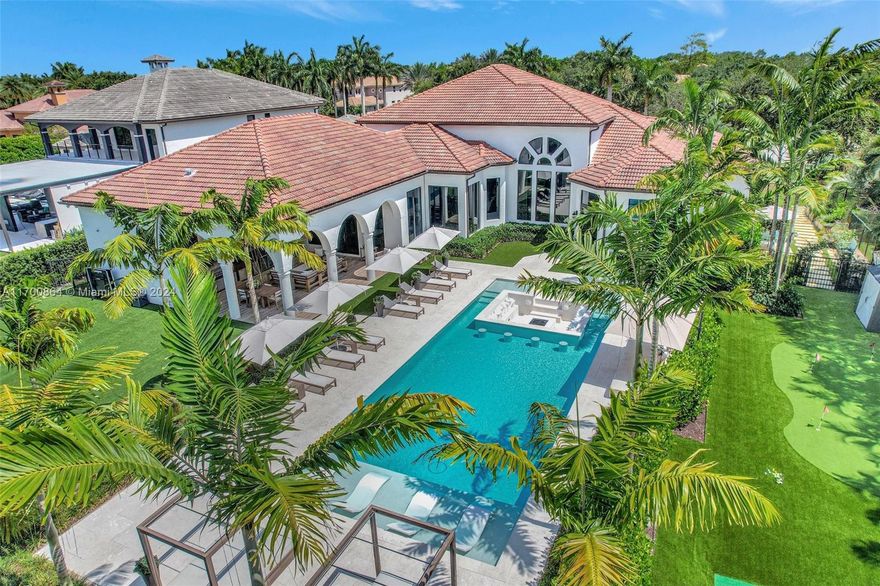 This show stopping 5 Bed, 6.5 bath home designed with attention to detail is nestled in the prestigious gated community of Stonebrook Estates. Grand entrance with high 25' ceilings & bright floor to ceiling windows. Some highlights include a luxurious master suite, custom bar, cozy theater and a built in wine cellar, surround system, impact windows/doors throughout, gourmet kitchen featuring gorgeous veined countertops, gas stove, custom cabinetry, top-of-the-line Dacor/Miele appliances & walk in pantry. The Resort-like backyard is every entertainer's dream featuring a 20'x60' heated pool w/ an inviting sunken fir pit & in-pool lounge chairs, a covered terrace w/ kitchen & living, green area for outdoor activates & even a basketball court! 3 car garage & oversized driveway.