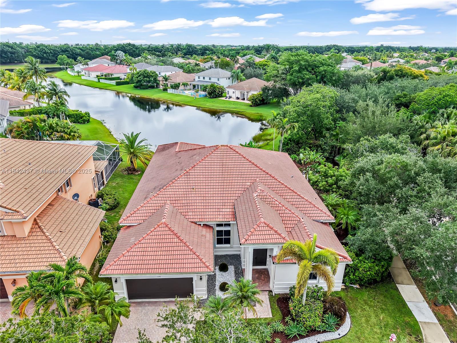 Gorgeous one-story lakefront residence nestled on a rare 12,000+ Sqft corner lot in the prestigious gated, resort-style community of Savanna. This beautifully designed 5-bedroom, 3.5-bathroom home features volume ceilings, fresh interior paint, and new stainless steel appliances. The spacious layout includes a serene primary suite with a sitting area and soaring 12-foot ceilings. The backyard is a private retreat offering peaceful lake views and plenty of room to build your dream pool. Additional highlights include accordion shutters throughout, newer A/C units (2025 & 2020), and a 2-car garage. Enjoy Savanna’s resort-style amenities—including a lap pool, waterslide, toddler pool, miniature golf, clubhouse, and more. Access to Weston's top-rated A+ schools, the best in town. Move in ready!