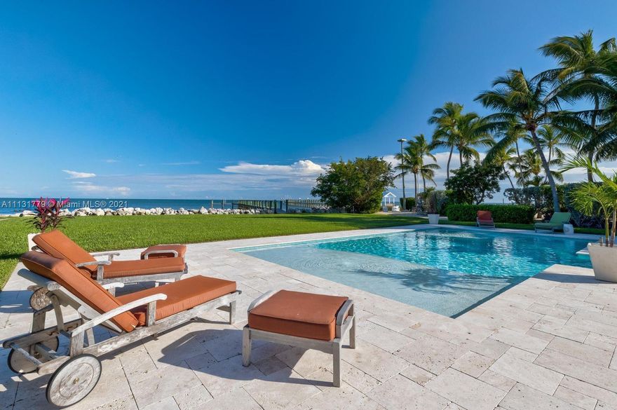 Ocean Blue ~ Lovely oceanfront estate on over 2 acres in Islamorada. Gated entry to your winding driveway through the trees to lead you to your own sprawling seaside sanctuary. This 3 bedrooms 2.5 bath home is waiting for you. Spacious 2 car garage and storage on the lower level. Open breezeway to your outdoor covered living areas steps from your custom-designed oceanfront pool with two sunning shelf areas complete with water features. Interior stairwell opens to your inviting large great room with cathedral ceilings allowing more natural light and views of the ocean. A stunning brand new kitchen with two sinks and a bar counter all overlooking the ocean. The 3 bedrooms and 2 .5 baths have an ideal layout with a spacious master suite situated overlooking the ocean.