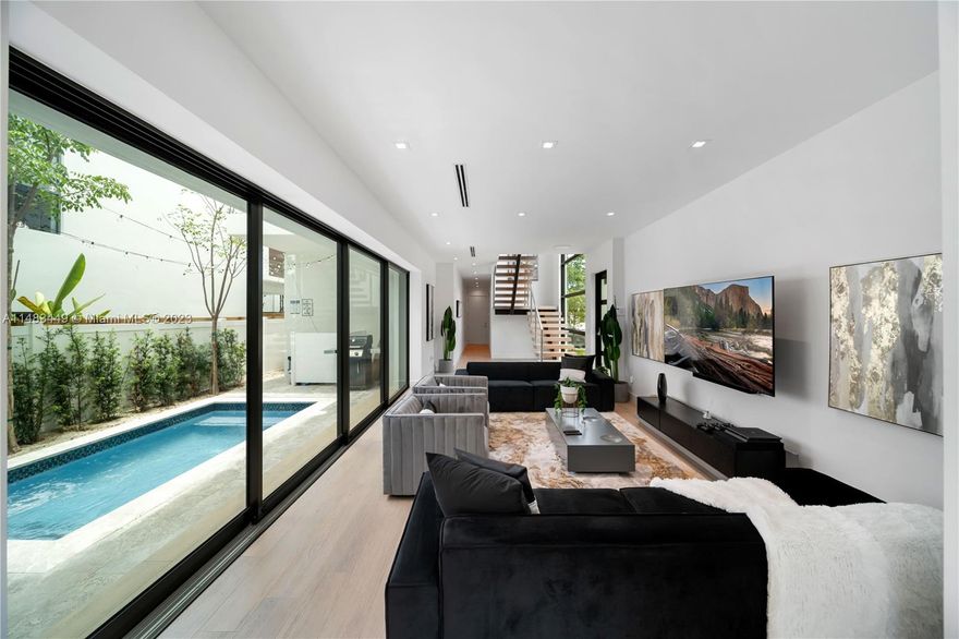 Welcome to this stunning new construction home in the desirable Coconut Grove neighborhood. Developed by Coco Homes and designed by renowned architect Omelio Arrabal, this modern masterpiece offers 5 bedrooms, 4.5 bathrooms, and a spacious 3,700 square feet of living space under air conditioning, this home truly embraces the concept of indoor/outdoor living. Step out onto the pool area through glass panels, where you can relax and enjoy the sunshine or take a refreshing dip in the plunge pool. The kitchen, designed by Veneta Cucine, features a gas range and a stunning island covered in exotic black marble, perfect for entertaining and culinary delights.