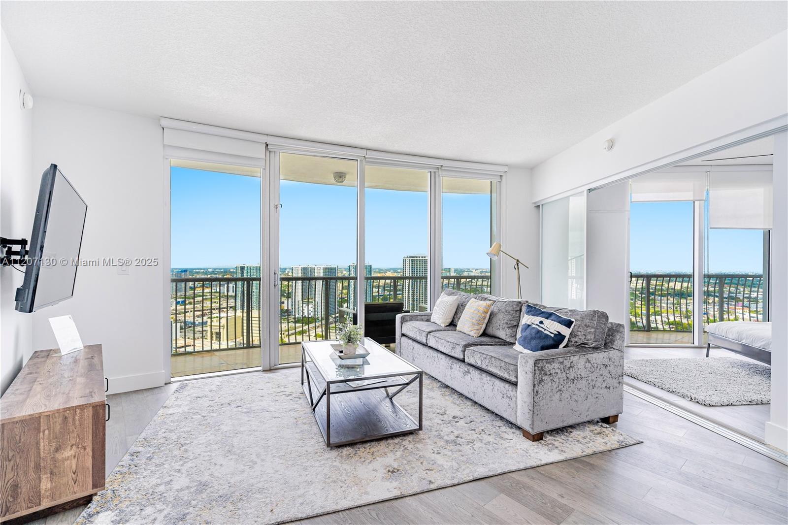 AVAILABLE 6/9/25: Imagine awakening each day to breathtaking panoramic views of downtown, the bay, and the ocean from the 39th floor of a luxurious unit, available for a minimum stay of 30 nights. The expansive wrap-around balcony invites you to embrace stunning sunrises and sunsets while savoring your morning coffee or evening wine. This prime location provides you with unrivaled city views, showcasing the iconic Miami skyline alongside the majestic ocean. Just minutes away, you’ll find the vibrant downtown nightlife, Bayside, exquisite dining experiences, a renowned theater, and the world-famous South Beach. Inside, elegant wood-look porcelain floors create a tranquil oasis, perfect for unwinding after a long day. Seize this extraordinary opportunity to elevate your living experience!