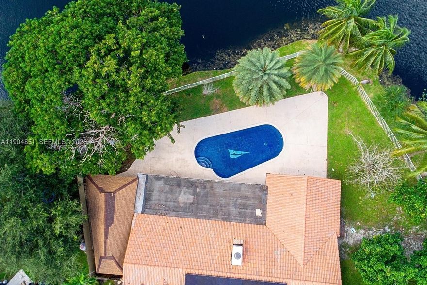 Location. Lot. View.
A rare opportunity to own a corner-lot waterfront home with the largest lot in the area and wide, unobstructed water views in one of Plantation’s most established residential communities.

Strategically located just 1 minute from I-595, offering effortless access to Fort Lauderdale, major business hubs, and the airport, while still enjoying a quiet, residential setting with spectacular sunset views reflected over the water.

This Mediterranean-style residence with Italian influences features 4 bedrooms plus a den, 3 bathrooms, a double-sided fireplace visible from two living areas, and a layout designed for both comfort and entertaining. Outdoors, enjoy a tile pool, expansive backyard, and unmatched open water scenery—ideal for relaxing or hosting gatherings.

Additional highlights include solar panels, no HOA, oversized driveway, two-car garage, and strong appreciation potential in a highly desirable location.

Minutes from Jacaranda Golf Club, a well-known Plantation landmark offering championship courses, lush landscaping, and an active golf and social lifestyle.

A unique waterfront property offering location, privacy, views, and long-term value—truly one of a kind in the area.