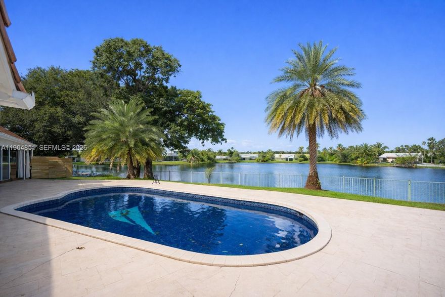 Location. Lot. View.
A rare opportunity to own a corner-lot waterfront home with the largest lot in the area and wide, unobstructed water views in one of Plantation’s most established residential communities.

Strategically located just 1 minute from I-595, offering effortless access to Fort Lauderdale, major business hubs, and the airport, while still enjoying a quiet, residential setting with spectacular sunset views reflected over the water.

This Mediterranean-style residence with Italian influences features 4 bedrooms plus a den, 3 bathrooms, a double-sided fireplace visible from two living areas, and a layout designed for both comfort and entertaining. Outdoors, enjoy a tile pool, expansive backyard, and unmatched open water scenery—ideal for relaxing or hosting gatherings.

Additional highlights include solar panels, no HOA, oversized driveway, two-car garage, and strong appreciation potential in a highly desirable location.

Minutes from Jacaranda Golf Club, a well-known Plantation landmark offering championship courses, lush landscaping, and an active golf and social lifestyle.

A unique waterfront property offering location, privacy, views, and long-term value—truly one of a kind in the area.