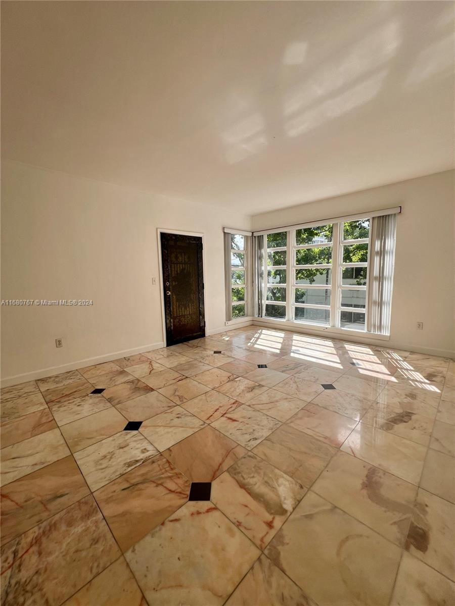 This two-bedroom apartment is located on Bay Harbor Island. It is an easy walk to the grammar school. It is on the top floor with open living space, high ceilings, corner windows, and great natural light. There is a washer and dryer off the kitchen. The kitchen has granite countertops, a built-in microwave, and Whirlpool refrigeration with a water and ice dispenser. There is also lots of storage space in the kitchen. The good-sized master bedroom has two closets. The second bedroom has corner windows. It has an assigned parking spot. Sorry no pets