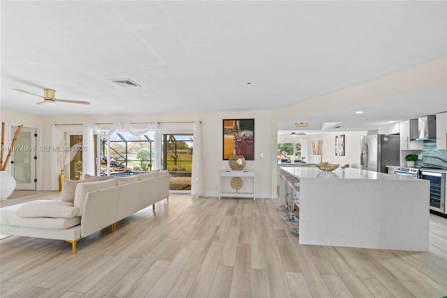 Open layout, lake views, private pool, and major upgrades—this home truly stands out. Beautifully updated 4BD/3BA/2 Car Garage/Pool estate. This modern ranch-style home offers seamless indoor-outdoor living, featuring retractable modern impact doors throughout that open to a screened-in lanai and pool—perfect for entertaining. Enjoy tranquil water views from multiple areas of the home, including the kitchen, which features new appliances. Additional highlights include a large laundry room with plenty of storage, 2-car garage, and an extra-large paver driveway with ample parking. A built-in pool waterfall, mature landscaping, and large mango fruit trees complete the backyard. Major upgrades include a NEW roof and NEW impact windows & doors. Situated on a quiet corner lot on a dead-end street for added privacy, and ideally located near Calvary Christian Academy, Pine Crest, Westminster Academy, major highways, Fort Lauderdale Executive Airport, and DRV PNK Stadium. Only 20 min from the beach. Amenities include, tennis court, basketball court, Olympic size pool and very low HOA.