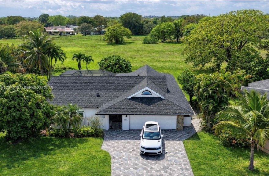 Beautiful Waterview/Pool Ranch-Style Estate in the Woodlands! This beautifully updated modern open-concept true 4BD/3BA entertainer’s dream home with a large laundry room and 2-car garage offers tranquil lake views throughout and a pool view from the kitchen. Perfect for gatherings with retractable doors that fully open to the pool area for seamless indoor-outdoor living. Features include new appliances, a large eat-in kitchen, extra-wide paver driveway, built-in pool waterfall, and mature mango trees. Large backyard to have your dream vegetable garden or enjoy with your pets. Major upgrades include NEW ROOF and NEW IMPACT WINDOWS & DOORS. Situated on a quiet corner lot on a dead-end street for a private small-community feel. Low HOA only $80/month with clubhouse, Olympic-size pool, new tennis courts, basketball court, and security patrol. Prime location near DRV PNK Stadium, Fort Lauderdale Executive Airport, Calvary Christian Academy, Pine Crest Academy, Westminster Academy, and major highways including the Sawgrass Expressway, Florida Turnpike, and I-95—location, location, location!