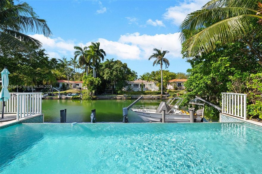 This exquisite 4-bedroom, 4.5-bathroom waterfront residence offers an unparalleled living experience, with direct access to the highly sought-after Coral Gables Waterway. It provides a 70-foot dock and a boat lift, perfect for boaters and water sport enthusiasts. The home has been meticulously updated, featuring an open-space layout designed to enhance the flow of natural light and views of the outdoors, including an infinity pool that seamlessly blends with the serene waterway. The well-appointed primary room showcases
oversized walking closets, a spa-like bathroom with dual sinks, and separate tub and showers. Its central location is near schools, businesses, entertainment and shopping districts, the airport, hospitals, and the Biltmore and Riviera Country Club golf courses