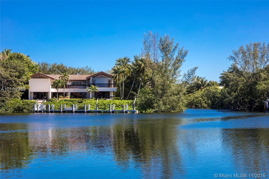 Over 300 ft of waterfront and wide water views with large dock on Lago Minore. Driveway leads to a secluded setting. The home has an open floor plan with the kitchen opening to the breakfast area & family rm overlooking the lagoon. Also on first floor, formal dining rm, office, guest bedrm & living rm enjoying an all-around view of waterway. Upstairs,4 suites, family rm & master bedrm w/den & wrap-around balcony. 2 car garage. Lot size: 26,416 sf. Cocoplum Sec 2 offers great indoor and outdoor amenities.