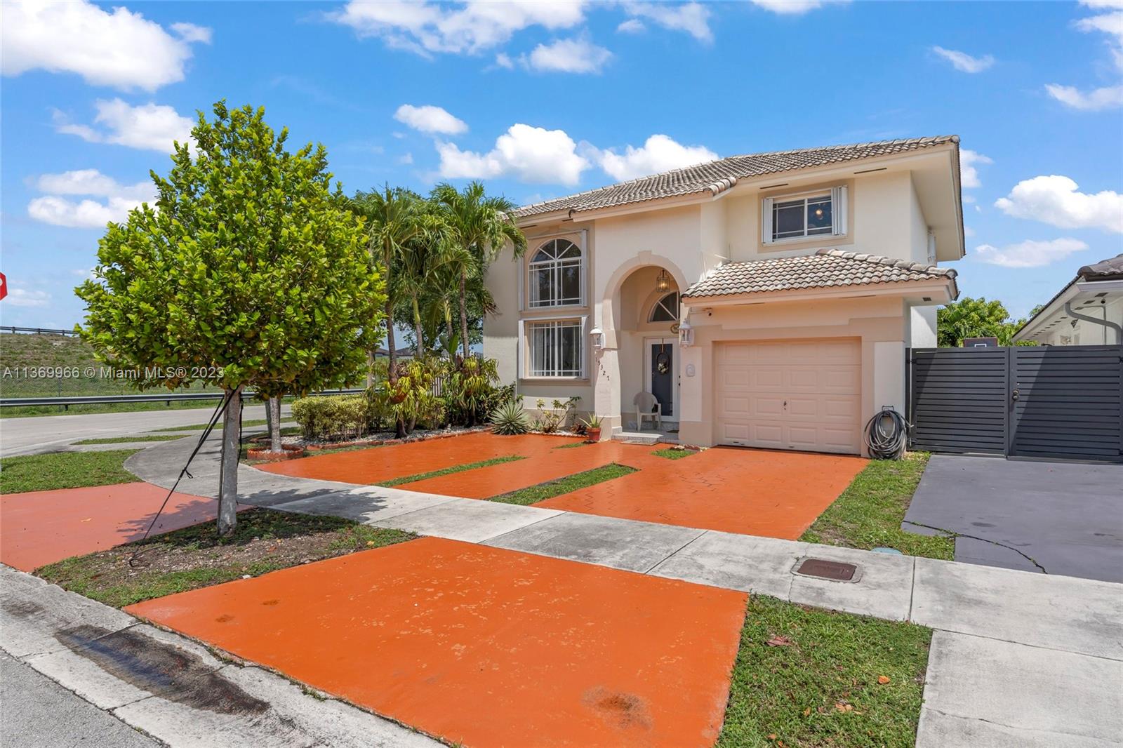 REDUCED! OPEN HOUSE SATURDAY 12:30-2. Wonderfully maintained 4 bedroom 3 bath home in Miami Lakes. Located on a corner lot, on a very low-traffic street, near major expressways and A-rated schools. Upon entry, you're greeted by a voluminous living/dining area with vaulted ceiling, 3 bedrooms, and 2 baths upstairs plus a converted garage and full bath downstairs. Features include granite tops, accordion shutters/impact windows, 3 year old AC, an instant water heater, and a dry roof. The rear patio has decorative rocks and concrete to reduce maintenance and the large awning provides plenty of shade. No association.