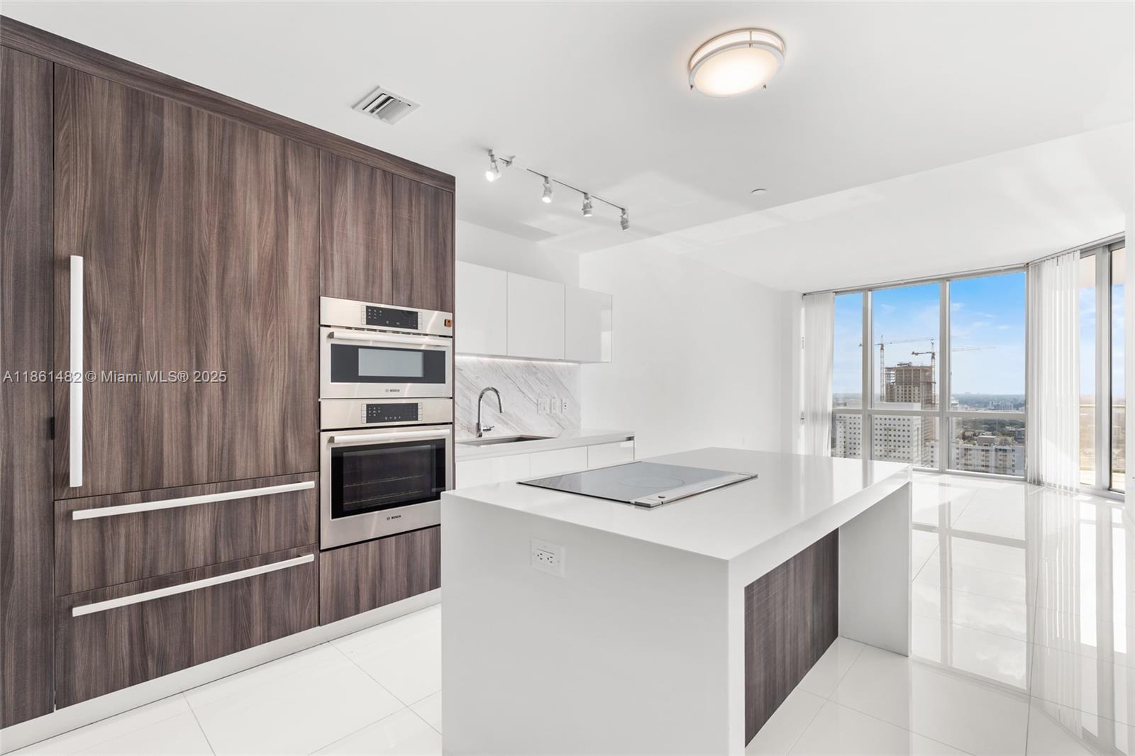 This stunning 1-bedroom, 2-bath luxury unit at Paramount Miami World Center offers an exceptional living experience. Featuring a private elevator, white ceramic floors throughout, and an oversized balcony with breathtaking sunset views of Miami, this home is truly one-of-a-kind. Enjoy built-out closets, blinds on all windows, and the convenience of 2 parking spots (1 valet & 1 assigned). The building boasts the world’s most amenities, including 5 pools, a spa, gym, basketball court, yoga studio, recording studio, racquetball, and more. With internet and cable included, this condo is perfect for both living and renting out. Don’t miss out on this incredible opportunity!----------UNIT RENTED TILL 11/5/2025, PAYS $4,500.00 PER MONTH - 24hs previous notice for tenant to open the door to show