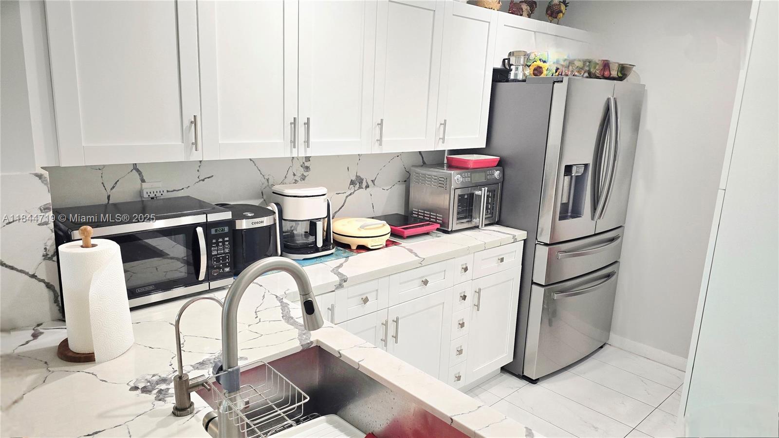 2 bedroom, 2 bathroom Corner Unit in the heart of Coral Gables. Split plan features a Modern Open Kitchen with raised ceilings, soft-close cabinets, and Granite Countertops. Both bathrooms are remodeled , tile flooring, NEW Hurricane Impact Windows, NEW AC unit , NEW Appliances. In-Unit Washer and Dryer, " 2 " Side-by-Side Covered Parking Spaces. Extra Storage in the Garage, Next to the Cars. The well-maintained building includes a Stunning Pool. This Apartment is just Steps from Downtown Coral Gables, where you can walk to fine dining, shops, and more. EASY TO SHOW.