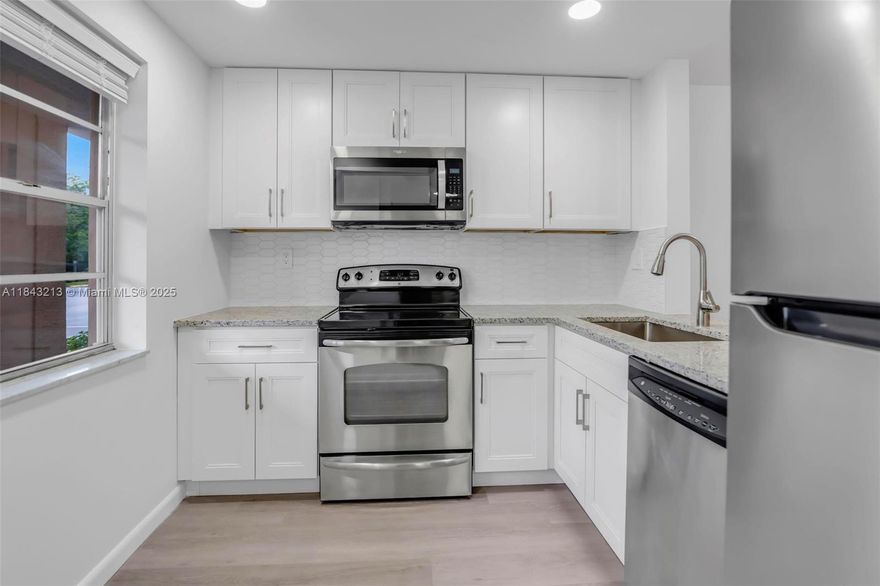 Substantially remodeled 1BR/1BA + sunroom condo in gated 55+ community. Features new luxury flooring, modern kitchen w/granite counters, soft-close cabinets & stainless steel appliances. Updated bathroom, new water heater, AC replaced in 2020. Bright & spacious first-floor unit w/pool & garden views—no stairs. Assigned parking right in front of unit, steps from laundry & storage rooms. Plenty of guest parking. Amenities: heated pool w/audio & WiFi, large clubhouse, BBQ area, shuffleboard & billiards. Stylish décor, low HOA. Excellent price—this unit will not last!