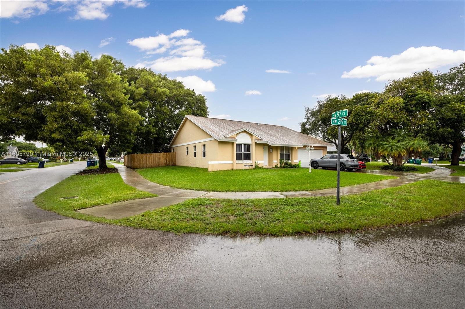 Beautifully positioned on a spacious corner lot in Lakes by the Bay, this bright and airy 4-bedroom residence offers high ceilings, a thoughtful split layout, and abundant natural light throughout. The expansive kitchen includes a pantry and opens seamlessly to the dining and living areas—perfect for everyday living and entertaining. Enjoy the large, fenced backyard with mature fruit trees and room for a pool, ideal for outdoor gatherings. Additional features include hurricane shutters, a utility/laundry room, and an attached 2-car garage.
