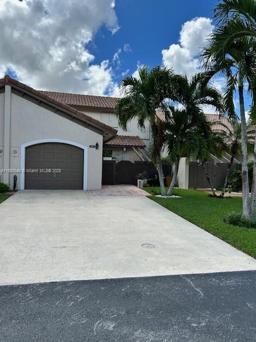 Stunning 3br/2.5B A Home in Exclusive Kings Court! Live in luxury in Kendall’s desirable gated community, minutes from shopping, dining, and the turnpike. This turnkey home features two master suites ( one upstairs, one downstairs), new floors,crown molding, modern kitchen with stainless appliances, two newer A/C  units, new washer and dryer, custom living room wall unit,new patio fencing, and automatic garage door. Enjoy resort-style amenities: clubhouse, pool, tennis & basketball courts, and playground. Move-in ready-just bring your furniture!