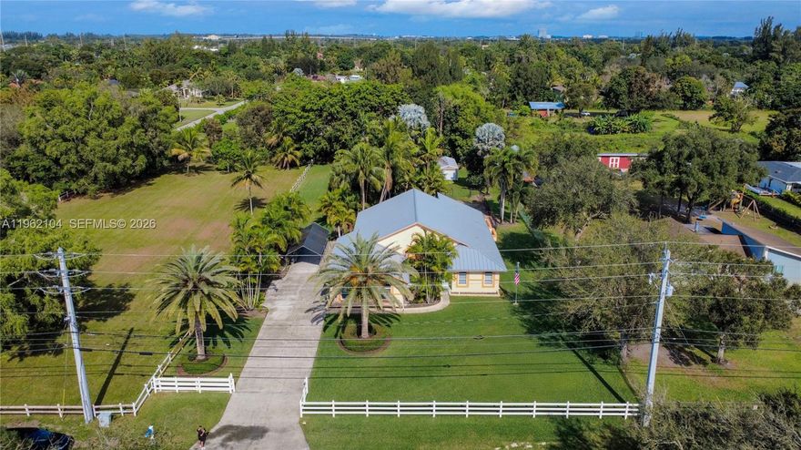 This stunning and meticulously maintained 4-bedroom, 2-bath home sits on 0.88 of an acre on a beautifully fenced property in a peaceful, highly desirable West Davie neighborhood that welcomes horses and all animals and offers the freedom of no HOA. The driveway leads to an ample and lush backyard setting. Major upgrades provide exceptional peace of mind, including a standing seam metal roof (2024), remodeled pool with new heater and pool lights (2025), hurricane-impact windows and doors (2023), additional hurricane panels and hardware for all openings and an alarm system, a hurricane-impact garage door with new opener (2023), and a two-year-old water heater. The freshly painted 2-car garage features epoxy flooring, New Age metal cabinets with stainless countertops, and an optional Advantage 9000-lb 4-post car lift, with the washer and dryer included. Inside, the kitchen offers generous cooking space with ample cabinetry, a pantry, KitchenAid appliances, and new quartz countertops and windowsills, while the living room showcases French doors overlooking a large, covered patio and pool, along with a divider that creates an additional front living space accented by custom artwork on the entry door. The spacious master bedroom with French doors sits off the main living area, cabana bath features a new quartz countertop, vanity, lighting, shower, and a custom stained-glass window.
