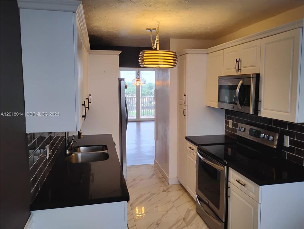 Photo of 250 Jacaranda Dr #608, Plantation, FL 33324 (MLS # A12018014)