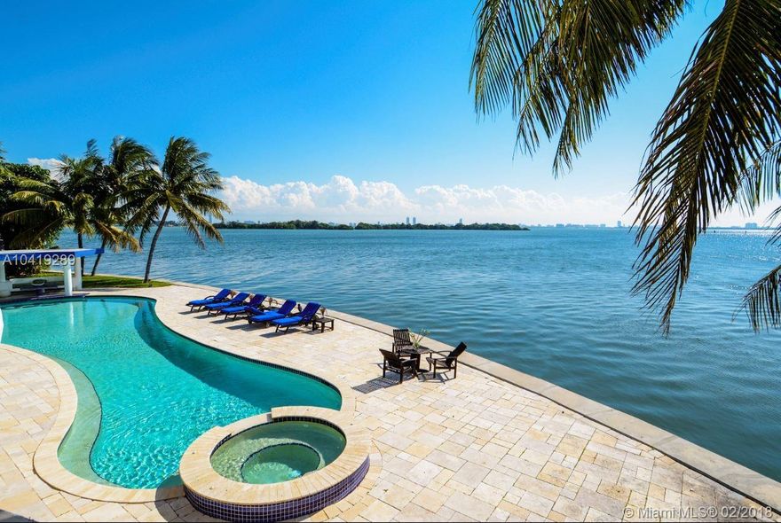 Paradise found on 300 feet on sparkling Biscayne Bay in a magnificent estate, perfect for large scale entertaining, a year-round vacation or a perfect family home. 2 Level Master Suite & 2 double suites in a split plan for a total of 7 bedrooms plus a bonus room. A ¾ acre on a private cul de sac with a 3 car garage, dramatic stairway off entrance, Fountain, close to the Beach, Design District, Bal Harbor Shops & Downtown Miami. Safe dockage for yacht on canal side. Silhouette-shaped oversized pool.