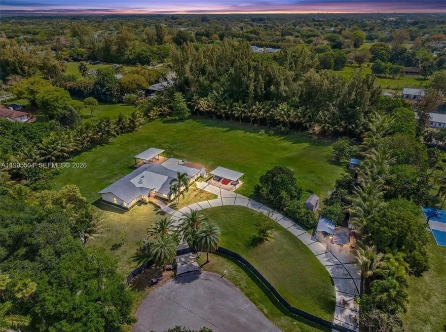 One-story fully updated estate on 2.3 acres in Royal Oaks, located on a quiet cul-de-sac. This exceptional rental opportunity features a beautifully renovated main residence along w/ a separate 1-bd/1-ba guest house. The main home offers approx. 3,000 SF w/ 4 Bd + Office and 2 Ba, featuring beautiful new marble flooring throughout, abundant natural light, and full impact windows & doors. Recent upgrades incl a new A/C, tankless water heater, a remodeled open kitchen w/ a modern island, contemporary wood paneling, & designer lighting fixtures throughout. The outdoor space includes a paved patio & a 20’x30’ pergola equipped with lighting and modern ceiling fans, ideal for gatherings and everyday enjoyment of the Florida lifestyle. The fully fenced backyard features palm and mature fruit trees such as mango and lemon. The property features a large circular driveway with two gated entrances, both remotely operated. Ample parking is available, including 7 carports and 2 EV charging stations. Add'l features include two storage sheds and a dog corral with fence and an insulated dog house. Water is included and supplied by a deep well system, with water purification maintenance covered by the owner, conveniently located near major highways, shopping, dining, equestrian facilities, and scenic riding trails. Offering a relaxed and private lifestyle with outdoor living, pet-friendly, and recreational activities, living the real Southwest Ranches lifestyle. Lease-to-own option available!