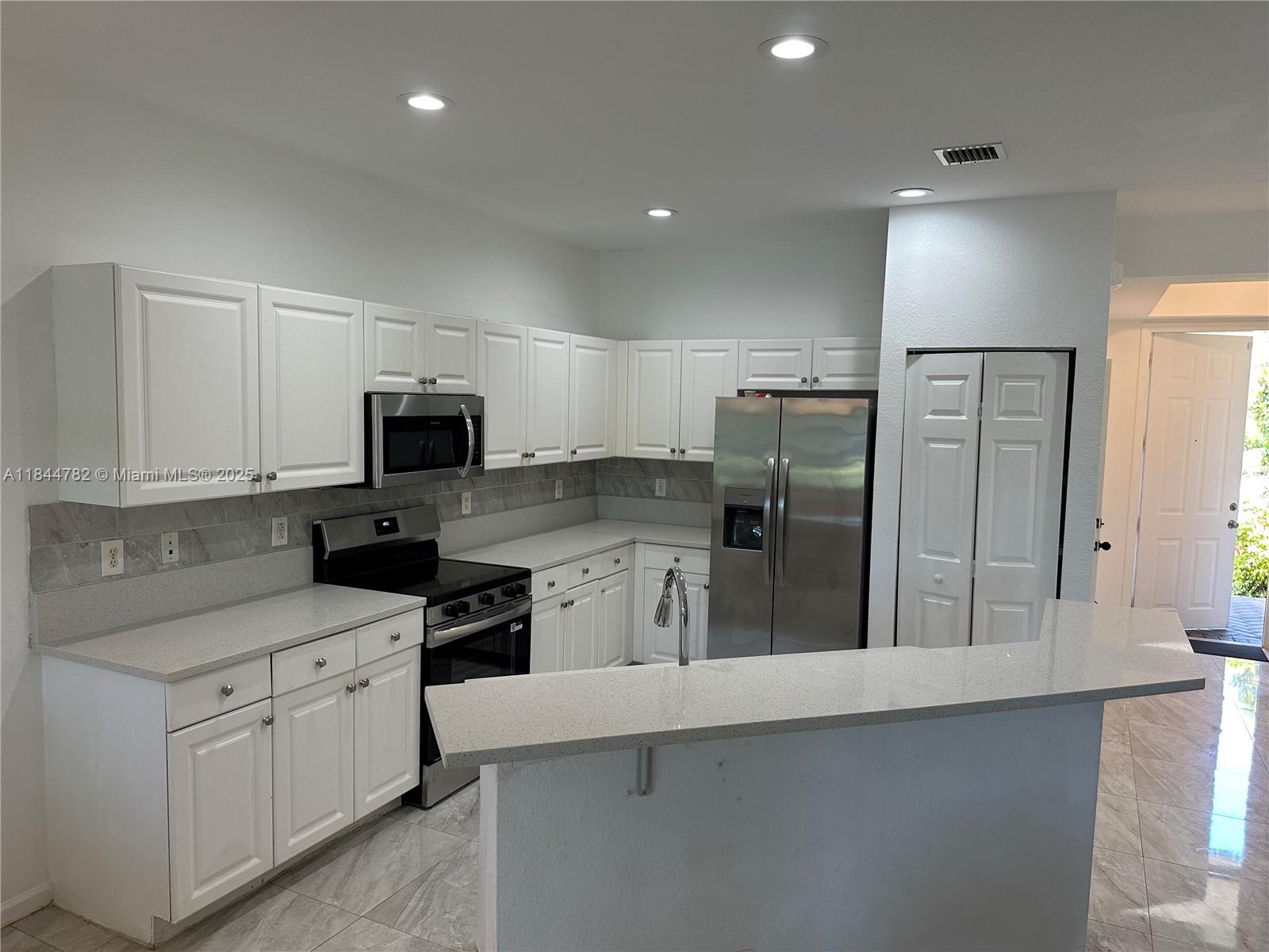 PRICE REDUCED !! Bring All Offers !! Largest Model Townhouse in Marsh Harbour (1,627 sf). Has a 1 car garage, wide lake view. Home has new Granite counters & Appliances. Features also include; ceramic tile floors & laminate wood floors. Full size washer & dryer, open floor plan, water view from bedroom, larger sized bedrooms, walking distance to club house. Great location, close to I-95, the beach & downtown Clematis St. Community has 24 hour guard gate security, club house, pool, tennis, gym & walking path around lake. Maintenance Fee includes; cable, exterior insurance (wind storm) and roof replacement. NOT A CONDOMINIUM! No crazy special assessments like condos have. Priced to sell, bring all offers! Owner wants a quick sale! These larger Townhouses rarely available for sale.