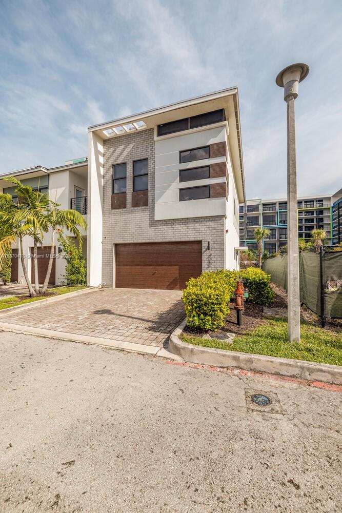 This stunning corner-unit townhome offers 3 bedrooms, 2.5 baths, and a spacious two-car garage in the heart of Plantation. Located in the gated community of Strata at Plantation, this residence blends modern design with everyday comfort. The gourmet kitchen features a two-tier countertop and stainless steel appliances, flowing seamlessly into the open living and dining areas, bathed in natural light from extra corner windows. Upstairs, the master suite is a serene retreat with a walk-in closet and spa-like ensuite, while two additional bedrooms provide generous space for family or guests. Additional highlights include impact windows, LED lighting, and a private balcony. Strata at Plantation offers resort-style amenities including a pool, fitness center, dog park, and clubhouse.