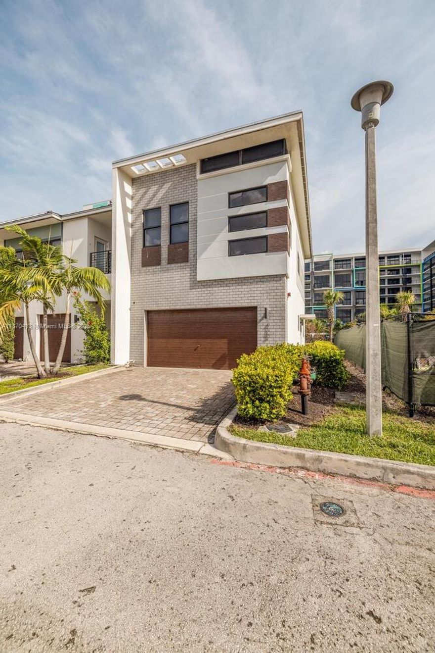 This stunning corner-unit townhome offers 3 bedrooms, 2.5 baths, and a spacious two-car garage in the heart of Plantation. Located in the gated community of Strata at Plantation, this residence blends modern design with everyday comfort. The gourmet kitchen features a two-tier countertop and stainless steel appliances, flowing seamlessly into the open living and dining areas, bathed in natural light from extra corner windows. Upstairs, the master suite is a serene retreat with a walk-in closet and spa-like ensuite, while two additional bedrooms provide generous space for family or guests. Additional highlights include impact windows, LED lighting, and a private balcony. Strata at Plantation offers resort-style amenities including a pool, fitness center, dog park, and clubhouse.