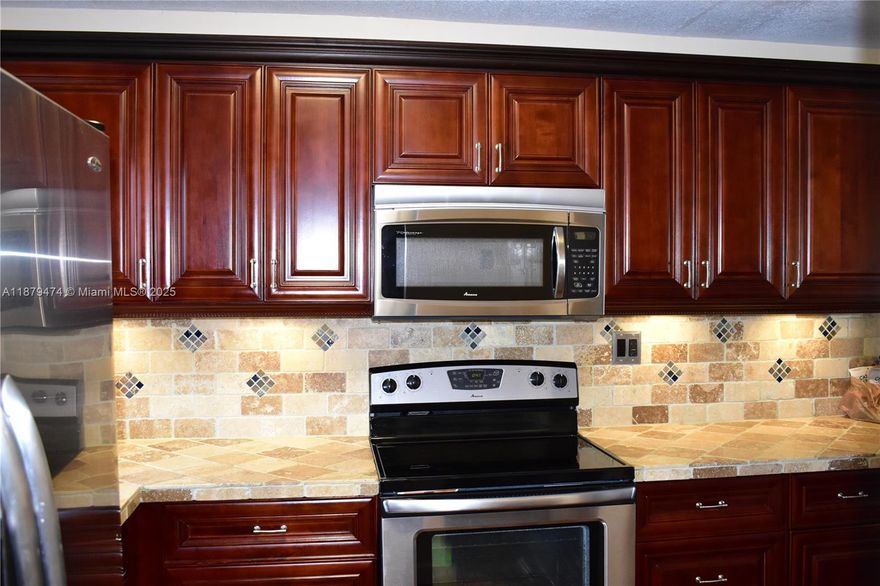 Do you want to not have any projects once you purchase? This one is special.  The kitchen was opened up (with permits) and expanded.  The cabinets are real wood.  All appliances are Stainless Steel and the counter is tiled and sealed.  The bathroom is converted to a shower and the floors in the main living area are real wood.  The high traffic areas are tile and the bedroom has matching wood but is made of high-end laminate flooring.  The windows are all impact except the sliding glass door.  The A/C (Trane) was installed in 2018 with the condenser installed in 2024.  It even features a tankless hot water heater.   Everything here is beautiful.  Please see this property if you are looking for a 1 bedroom.  See Matterport virtual tour link.