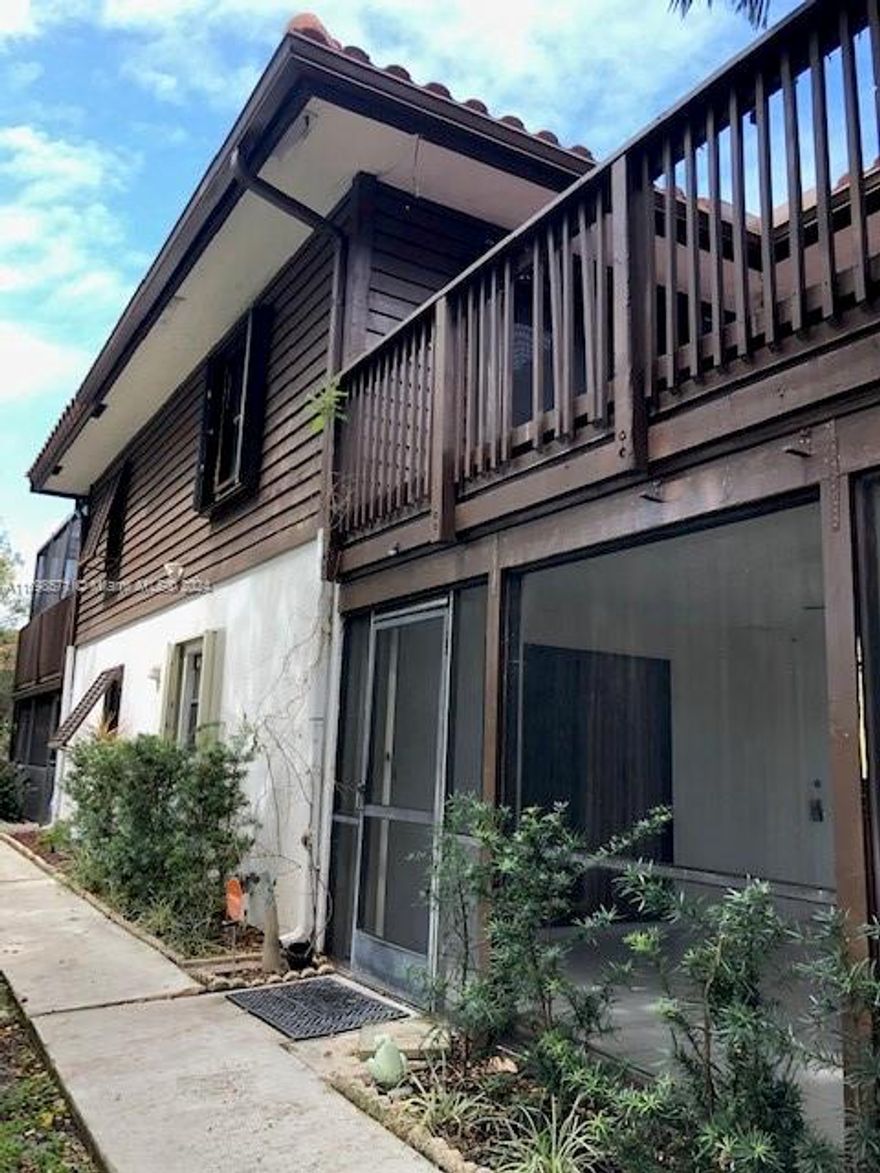 Rent this beautiful and spacious townhome with two master suites located close to downtown Boca and the beach! Large, open kitchen has been upgraded with granite counters, oak cabinets, custom faucet, double pantry and includes 17 feet of countertop! Wood laminate and tile floors.  Fenced, covered and screened tiled patio downstairs perfect for entertaining. Both bedrooms upstairs have full baths plus sliding door access to a sun deck/balcony. Accordion shutters on all windows.
