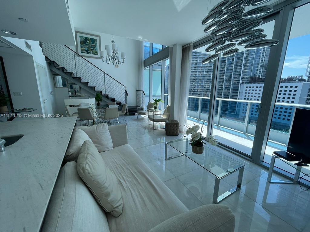 Modern Townhouse at Epic - 1,430 sq ft with Spectacular View. Experience luxury in this impressive townhouse apartment located in the iconic Epic building, in the heart of Miami. This elegant two-story residence is distinguished by its modern architecture and imposing floor-to-ceiling glass windows, which flood every corner with natural light and offer panoramic views of the city and the Miami River.
Enjoy high-end finishes, high ceilings, a gourmet kitchen equipped with state-of-the-art appliances, and generous spaces that combine functionality with style as an Epic resident, you'll have access to all of the building's exclusive amenities, including pools, a spa, a state-of-the-art gym, and concierge service.