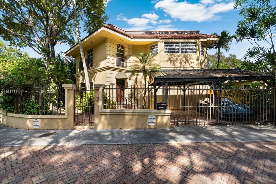 Steps from Coconut Grove’s vibrant village center, this 2-bedroom (plus large office) home offers location, lifestyle, and potential. With approx. 2,090 SF, portions feature double-height ceilings & abundant natural light, creating an open, airy feel. The office is ideal for working from home or as a creative retreat. A small, charming garden provides space to relax or enjoy time outdoors with a pet. Fully walled & gated, the home also includes a 2-car carport for convenience and privacy. Built in 1991 and ready for updating, this home is an excellent opportunity to reimagine a well-designed layout in one of Miami’s most desirable neighborhoods. Enjoy the Grove’s lush canopy, vibrant energy, and walkable access to restaurants, cafés, and bayfront parks — all just moments away.