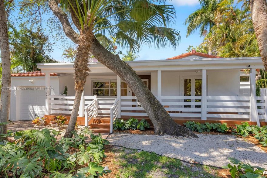 The quintessential Coconut Grove lifestyle awaits you in this renovated home near Merrie Christmas Park. Lush foliage and a mature tree canopy accent the over 9,300 sqft property offering a true tropical oasis. From your sweeping front porch, step inside this light and bright home with modern finishes and original charm. Refinished hardwood floors, wood burning fireplace, polished and renovated kitchen and en-suite baths plus views from every room. The oversized primary suite offers walk-in closet and sliding glass doors out to the wraparound wood deck and sparkling lap pool. Two long driveways plus one-car garage offer ample parking. New roof installed in 2024. Enjoy proximity to top schools, parks, entertaining and restaurants. Make a piece of the South Grove your own!