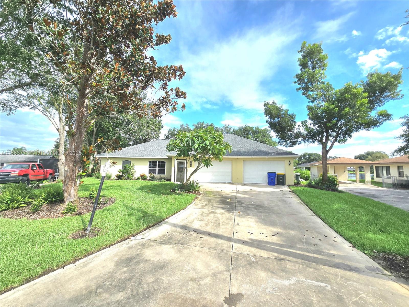 Welcome to this spacious 3-bedroom, 3-bath home in the desirable Erin Parks Canals neighborhood! Featuring an open floor plan with vaulted ceilings, a breakfast bar kitchen, and a split-bedroom layout for privacy. The primary suite offers a private bath, and the 550+ sq ft Florida room (under air, not in main sq ft) includes a wet bar—great for entertaining. Enjoy canal views from the backyard, with a rear garage door and ramp access for boats or jet skis. The 3-car pass-through garage spans over 1,400 sq ft and includes a full bath, perfect for storage or a workshop. New roof installed July 2025. Florida living at its best!