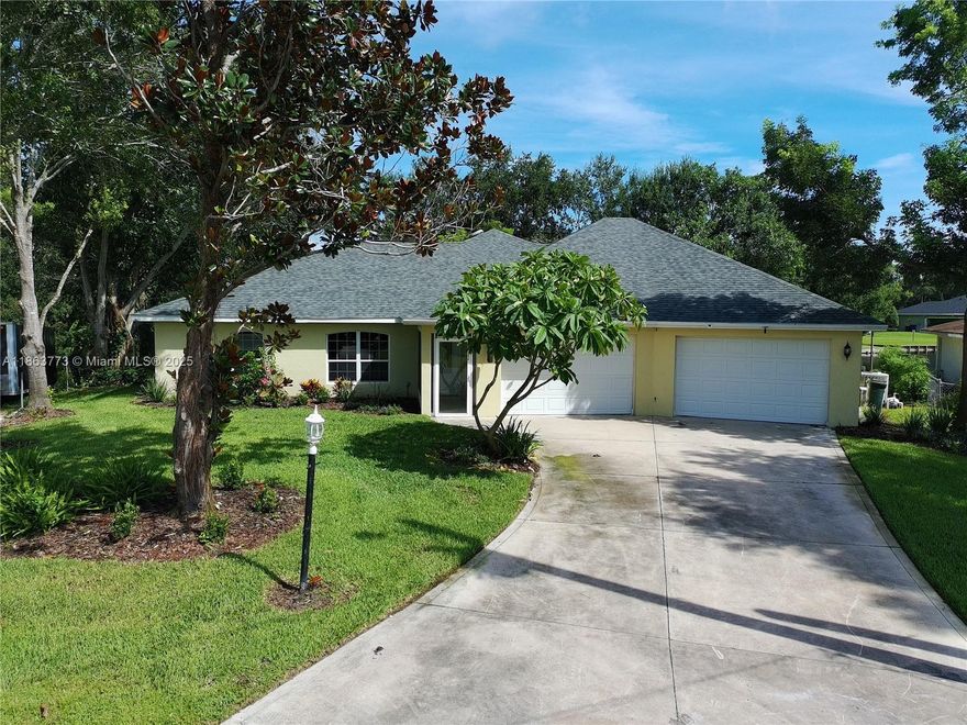 Welcome to this spacious 3-bedroom, 3-bath home in the desirable Erin Parks Canals neighborhood! Featuring an open floor plan with vaulted ceilings, a breakfast bar kitchen, and a split-bedroom layout for privacy. The primary suite offers a private bath, and the 550+ sq ft Florida room includes a wet bar—great for entertaining. Enjoy canal views from the backyard, with a rear garage door and ramp access for boats or jet skis. The 3-car pass-through garage spans over 1,400 sq ft and includes a full bath, perfect for storage or a workshop. New roof installed July 2025. Florida living at its best!