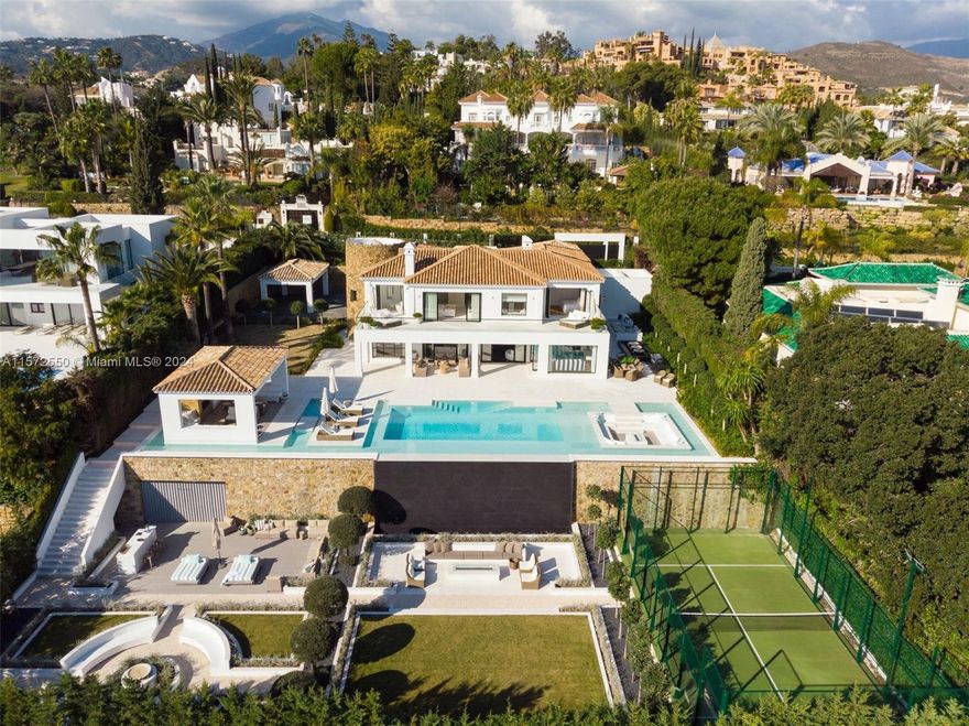Property is located in Marbella, Spain. This three-level residence offers spectacular Mediterranean Sea views, surrounded by lush greenery for privacy. Outdoor spaces include an infinity pool, sunken chill-out area, pergola with a fireplace, and chill-out spots. The expansive plot features an extravagant garden, private padel court, and al fresco dining space. Inside, enjoy Mediterranean architecture with modern elegance. The kitchen boasts state-of-the-art appliances and sea views. Villa Mulligan has four ensuite bedrooms, a grand master suite, and amenities like a home cinema, treatment room, and SPA. A sanctuary of sophistication in the heart of Nueva Andalucia.