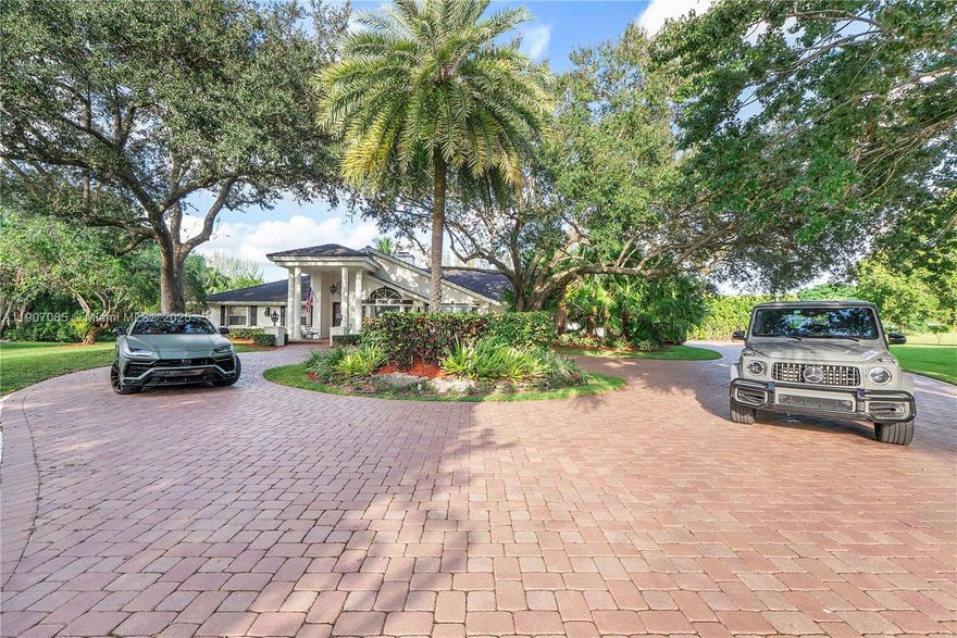 Coral Springs Incredible waterfront estate on a private cul-de-sac in the exclusive Whispering Woods community. Elegantly renovated with new plank flooring, a professional-grade kitchen, and a luxurious primary suite with a spa-inspired bath. Over 5,000sqft of open living and entertaining space featuring vaulted wood-beam ceilings, a striking two-sided fireplace, and a spacious room ideal for a gym, playroom, or in-law suite. Impact windows and doors, newer concrete tile roof, and exceptional outdoor living with a resort-style pool, spa, and tiki entertainment area. Set on one of the largest lots in the neighborhood with outstanding curb appeal easy to show and sure to impress. Huge price reduction - Furniture sold separately !!