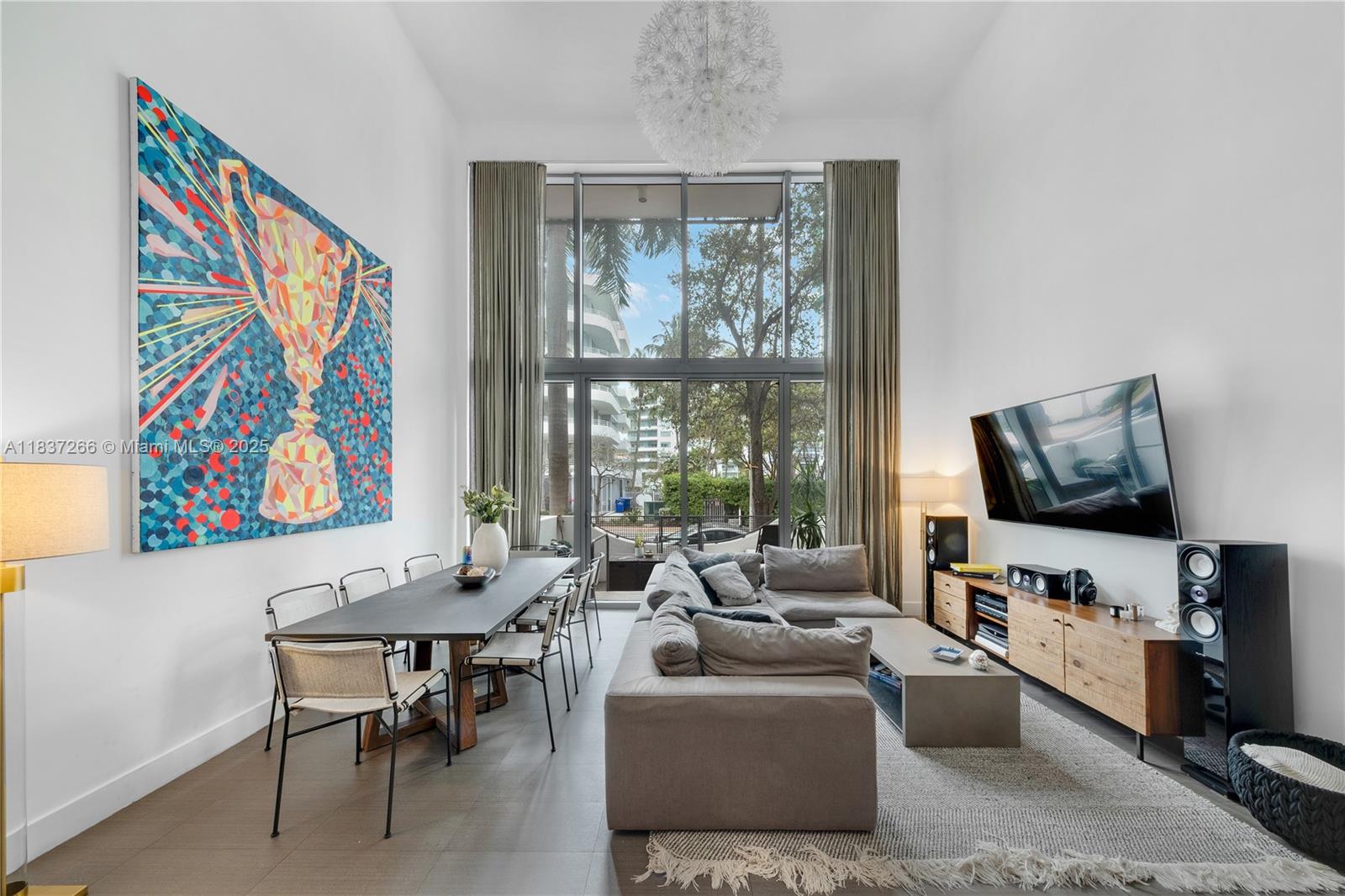 Welcome to Terra Beachside! This loft-style two-bed/two-bath unit comes with a versatile flex space/den and unique floor plan that offers privacy with one bedroom downstairs and master bedroom upstairs. The 18+ foot ceilings bring in natural light, creating a bright and airy atmosphere. The loft/den on the second floor provides flexibility, whether it's used as a TV room or an office. The master bedroom features a spacious walk-in wardrobe, dual showers, and a private balcony. Additionally, the unit has a private yard. Nestled in a boutique building, this home epitomize the Miami Beach lifestyle. Residents can easily access hotels, restaurants, cafes, and the ocean. Embrace beachfront living and escape the city life! Building requires a Tenant Security Deposit = 1 mo rent, paid by tenant.