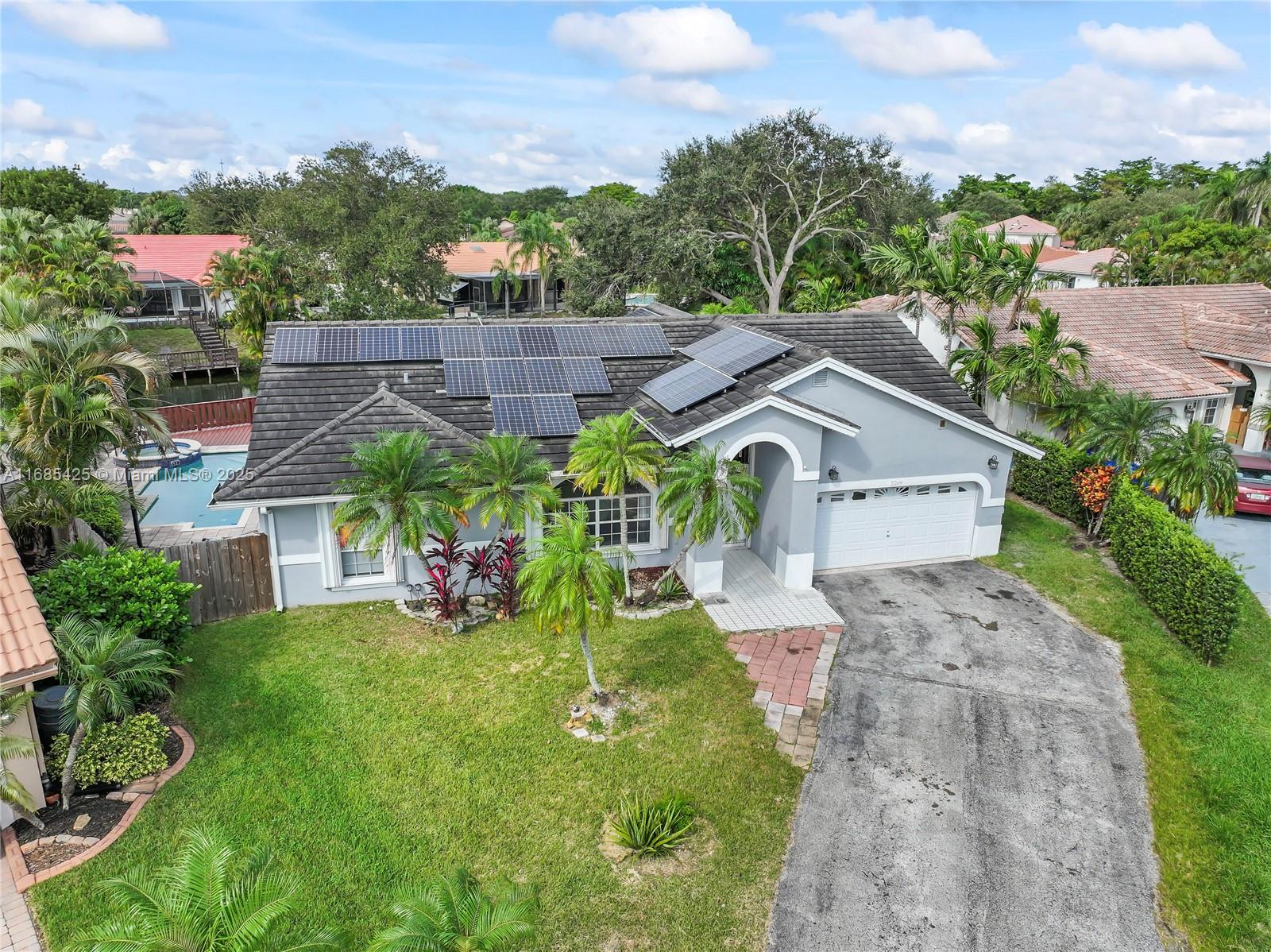 Step into this stunning 4-bedroom, 2-bathroom, 2-car garage home with over 2,000 sqft under AC. The updated kitchen features a large island with granite countertops, elegant backsplash, stainless steel appliances, and white cabinets with crown molding. Flooded with natural light, the kitchen also includes a skylight, enhancing its welcoming ambiance. Access the spacious, screened lanai from the kitchen, dining room, and master bedroom, creating a seamless indoor-outdoor flow. Outside, enjoy a massive deck perfect for entertaining, a pool with spa, and a generous yard right on the canal/lake. Solar panels significantly reduce or even eliminate the electric bill. Centrally located, this home offers style, comfort, and stunning waterfront living.