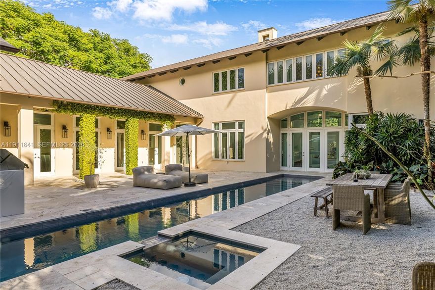 Cocoplum modern tropical luxury home. 5-beds, 5.5-baths custom residence defined by a transitional architecture and design, seamless indoor–outdoor living. An open plan with soaring ceilings showcases a chef’s kitchen - dark granite, gold accents, butcher-block island, pro appliances-, a serene primary suite, and dedicated wellness spaces including a high-end gym, steam and dry sauna. A resort-style lap pool & spa anchor an expansive stone patio with a fully equipped outdoor kitchen, including pizza oven, grill, ice-maker, wine cooler, private dining, lush landscaping, and privacy hedge. Very high elevation with a rare NO flood insurance necessary, a dark metal roof, and an elegant paver drive complete this exceptional turnkey residence.