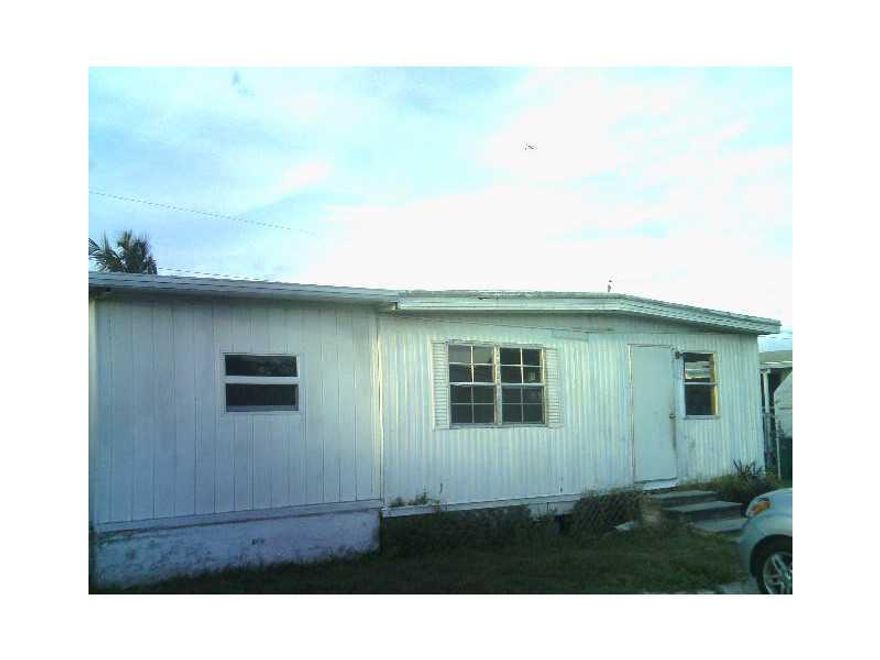 OWN THE LAND!  NO LOT OR HOA FEES!  Large 4 or 5 bedroom, 2 bath mobile home in desirable Davie neighborhood with A-rated schools.  Fenced yard, open floorplan, remodeled kitchen,  laundry room.  Roof 5 years old. Low taxes. Minutes to shopping, highways,  transportation. Low taxes. Municipal water and sewer.  With a little work, this can be your dream home!  Sold AS-IS.Seller motivated. Easy to show by appointment after 3pm.  Pets on premises.