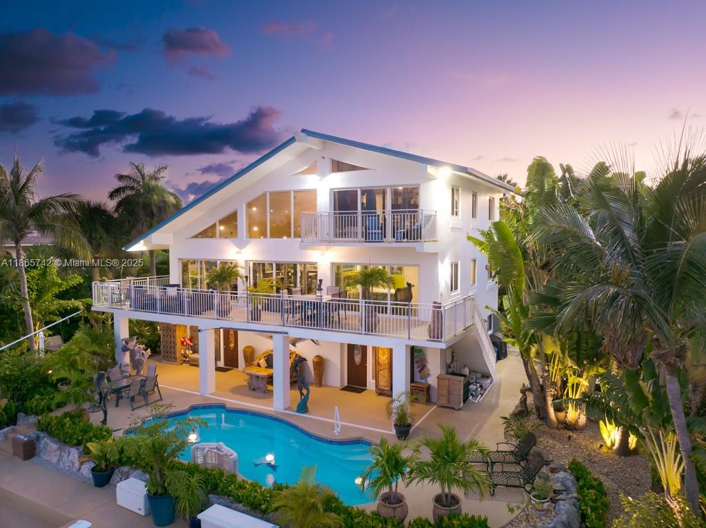 This wonderfully remodeled three story home in exclusive Coco Plum has a spacious open layout with exceptional water views. A grand staircase enters the two-story great room, perfect for entertaining. The existing 4 bedroom, 3&1/2 baths can easily be converted to add a 5th bedroom. An updated kitchen features all new stainless-steel appliances and granite countertops. The 110' concrete dock with two 40' finger piers provides unmatched deep-water dockage with direct ocean access. A 200' wide canal allows easy access to dock multiple 50’ yachts, room for all the toys and included amenities such as floating jet ski / kayak docks, davits, filet station, ice machine, etc. Enjoy the sunshine in the sparkling heated pool surrounded by lush tropical landscaping. Own your piece of paradise!